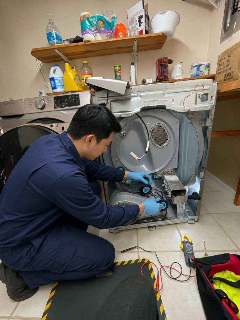 FastFix technician replacing drum rollers inside an opened dryer at a Tri-Cities home